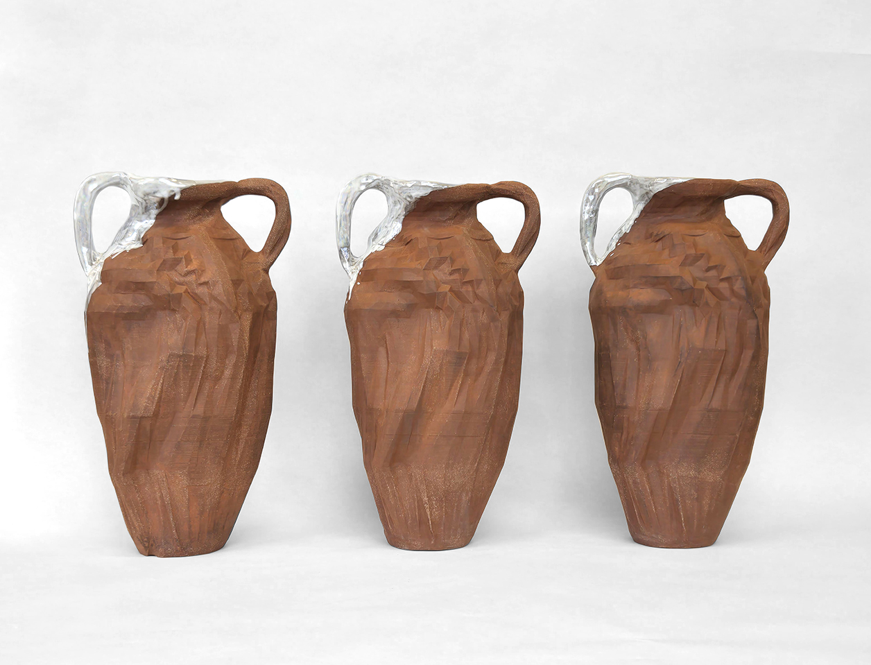 image of 3 ceramic vessels that look like amphoras but are altered using slip cast stoneware and mixed media